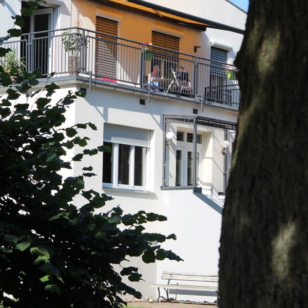 Bewohner auf dem sonnigen Balkon des Gutshauses